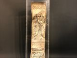an old scroll in a glass case on a black background