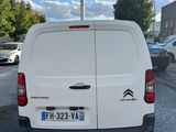 the back of a white van parked in a parking lot