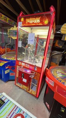 several arcade machines in a room with a lot of toys