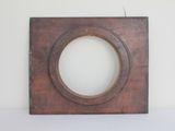 a picture of a wooden frame on a white wall
