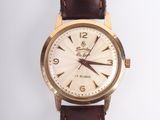an image of a close up of a wrist watch on a white surface