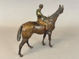 statue of a man riding a horse with a bird perched on his back
