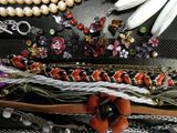 many different types of bracelets and necklaces laid out on a table