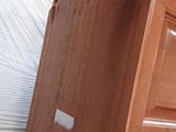 a wooden cabinet that has a door on top of it
