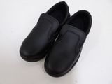 pair of black leather shoes on a white surface with a white background
