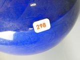 a blue vase with a white sticker on it