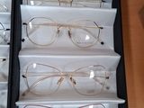 several pairs of glasses are in a box on a table