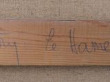 a piece of wood that has writing on it