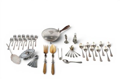 many different types of silverware and spoons laid out on a table