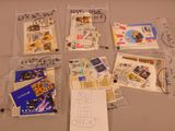 many postcards and envelopes that are on the table