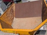 a yellow dump truck that is parked next to a pile of dirt