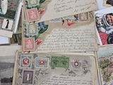 a pile of old letters and postcards sitting on a table