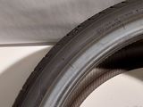 a close up of a tire on the side of a wall