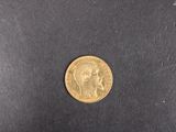 a close up of a gold coin on a black surface