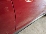 a close up of a red car with a red emblem on it