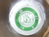 a close up of a bottle with a green label on it