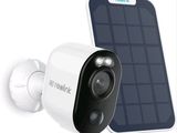 a close up of a solar powered security camera next to a cell phone