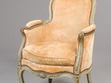 an old fashioned chair with a beige upholstered seat