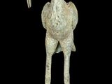 pair of bronze flamingo sculptures on black background with black background