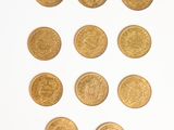 several gold coins arranged in the shape of a heart on a white surface