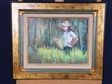 a painting of a woman with a straw hat on a easel