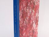 a book that is sitting on a white surface