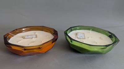 two candles are sitting side by side on a gray surface