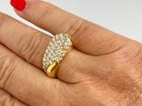 someone is holding a ring with diamonds on it in their hand