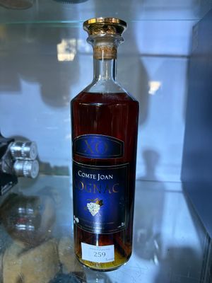 a bottle of wine sitting on a glass shelf