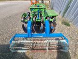 a tractor with a plow attached to the back of it