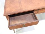 a small wooden desk with a drawer underneath it