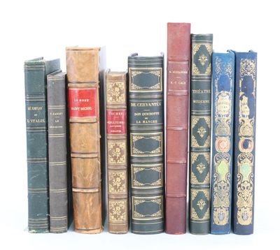 several old books are lined up in a row on a white surface