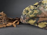 a camouflage hat and a rope on a table