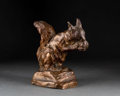 bronze sculpture of a squirrel on a rock on a black background