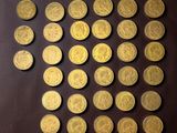 some gold coins are arranged in a circle on a brown surface