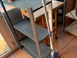 a broom and a mop on the floor in front of a window
