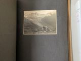 an open book with a picture of a mountain in it