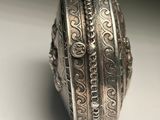 a close up of a silver ring on a white surface