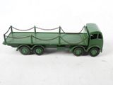 a green toy truck with chains attached to the back of it