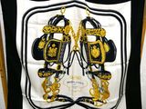 black and white scarf with gold chains and purses on it