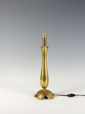 an image of a gold table lamp on a white surface