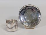 silver plate with a silver cup and saucer on a stand