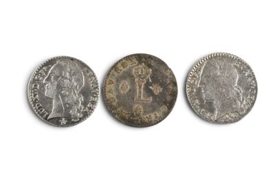three different types of coins on a white surface