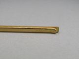 a gold plated pen on a white surface