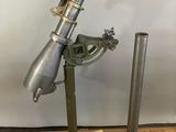 a metal telescope on a wooden stand with a metal pole