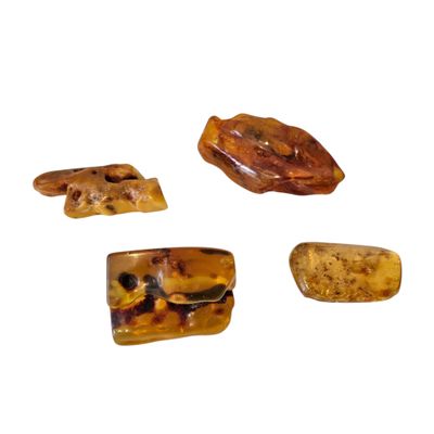 four pieces of brown and black stone on a white surface