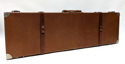 a brown suitcase sitting on top of a white table