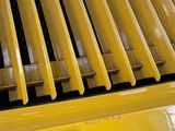 a close up view of a yellow machine with yellow bars on it