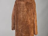 a woman ' s brown fur coat on a mannequin mannequin