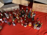 many bottles of alcohol on a table with a red table cloth